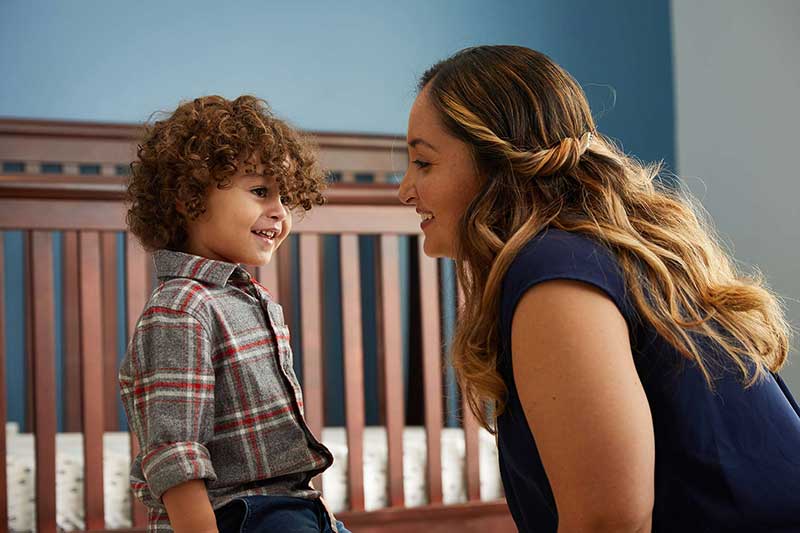 mom chatting with son in his bedroom